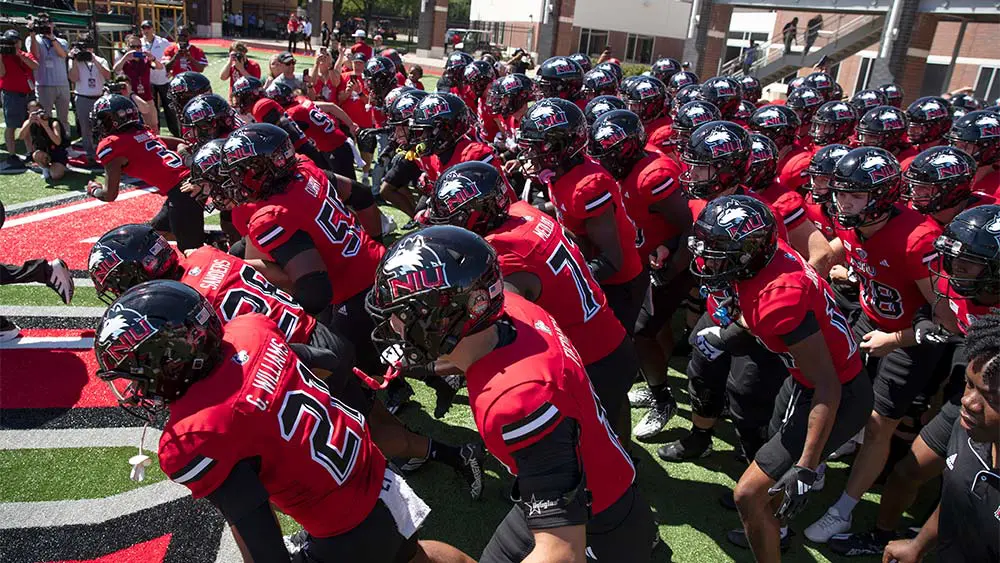 football players running onto the field